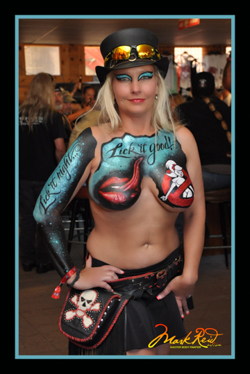 blonde woman with an elaborate design painted on her chest